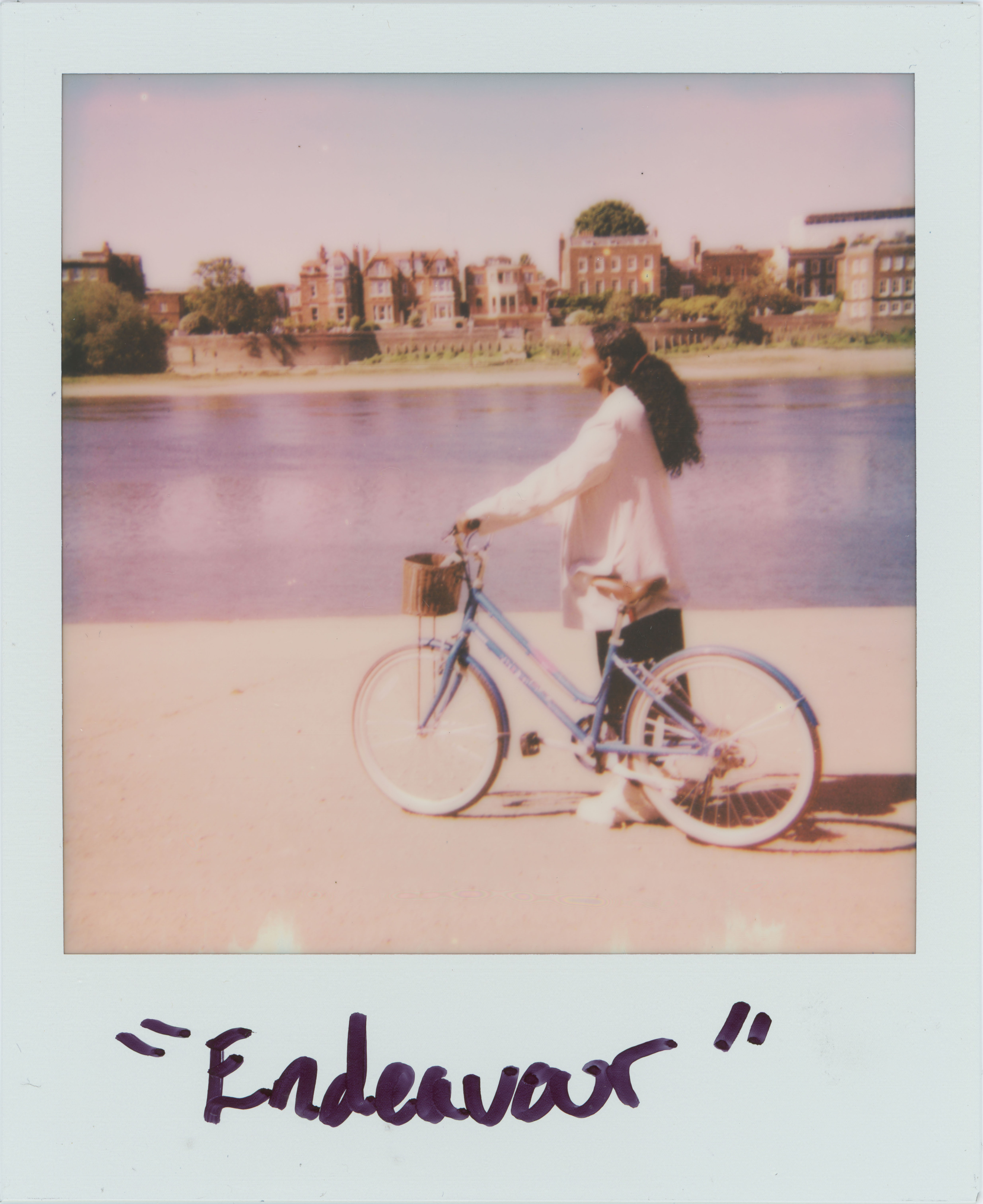 woman holding a bike in front of a lake