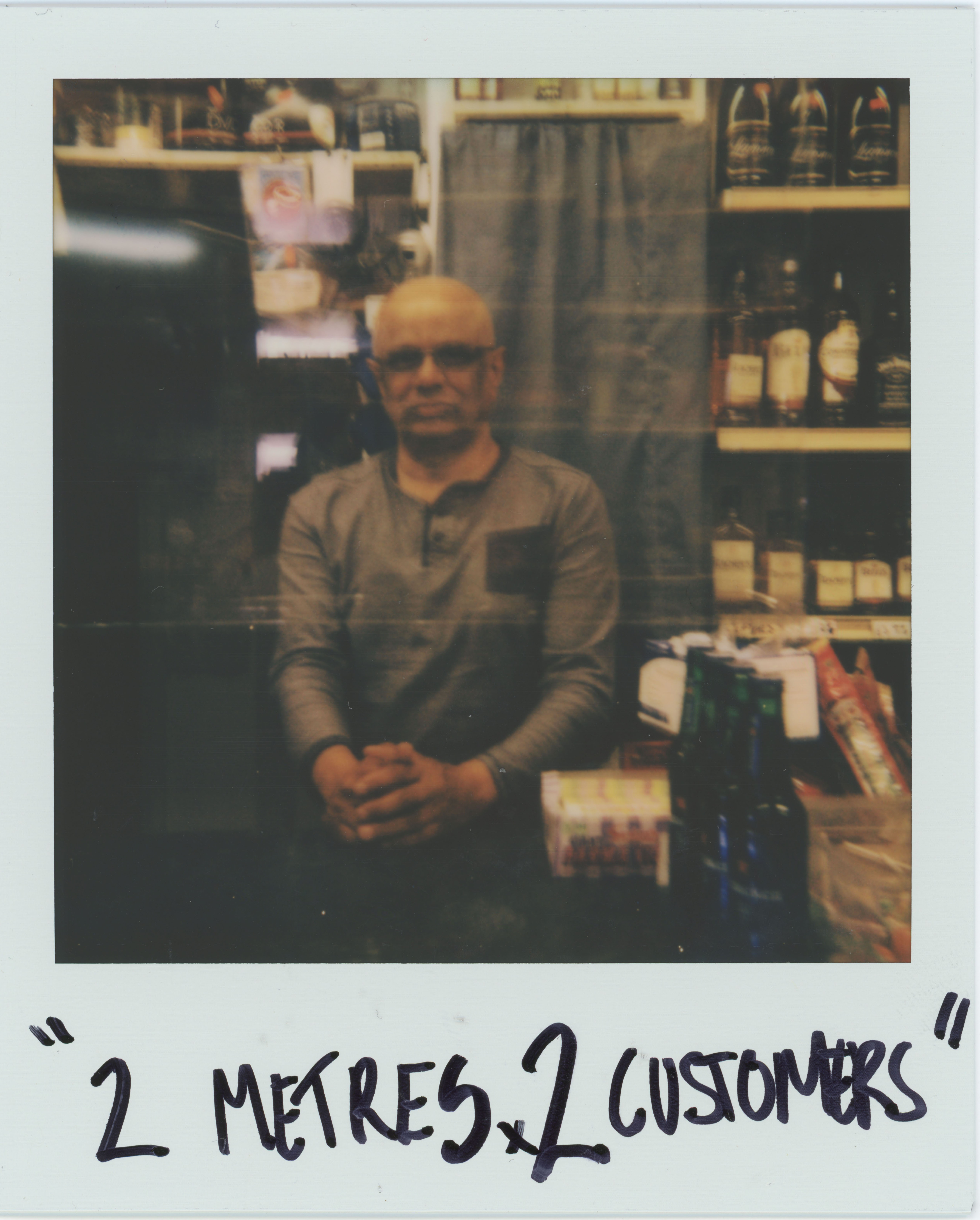 man behind shop counter